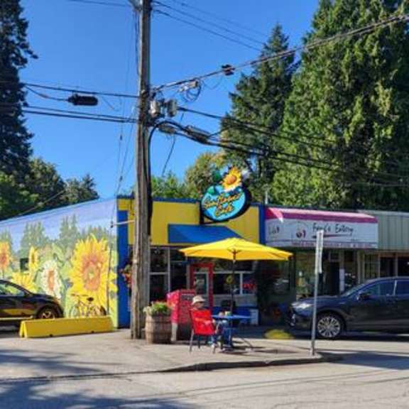 a sunflower mural is on the side of a building.