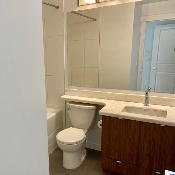a white toilet sits next to a sink in a bathroom.