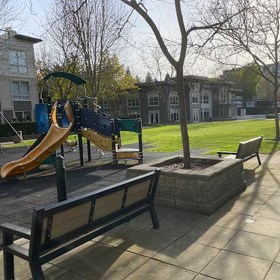 a playground with a slide and a bench.