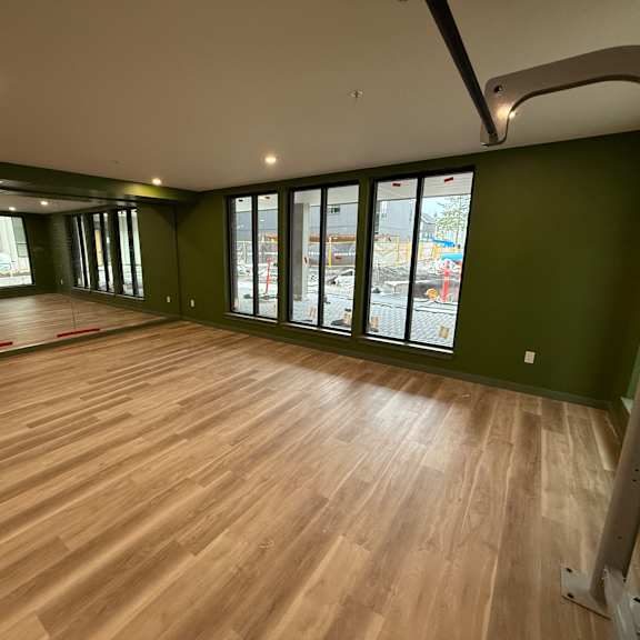 a room with wooden flooring and green walls.