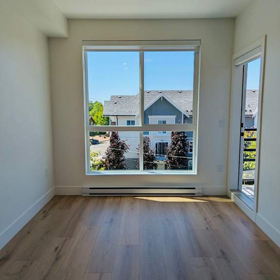 a room with a large window overlooking a residential area.