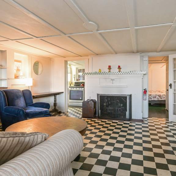 a living room with a black and white checkered floor.