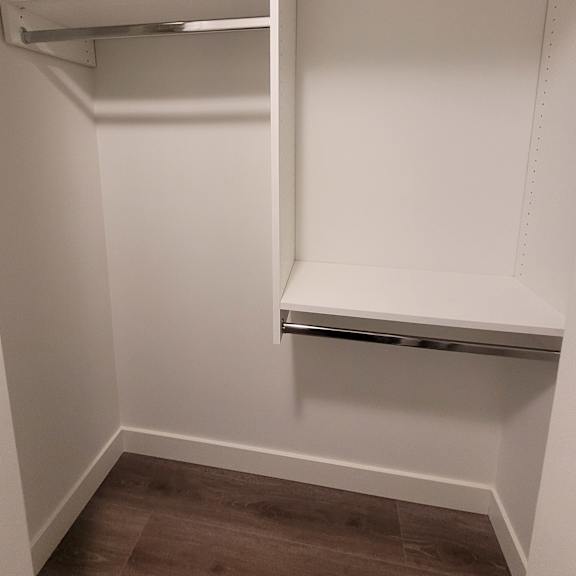 a white shelving unit with a door on the right side.