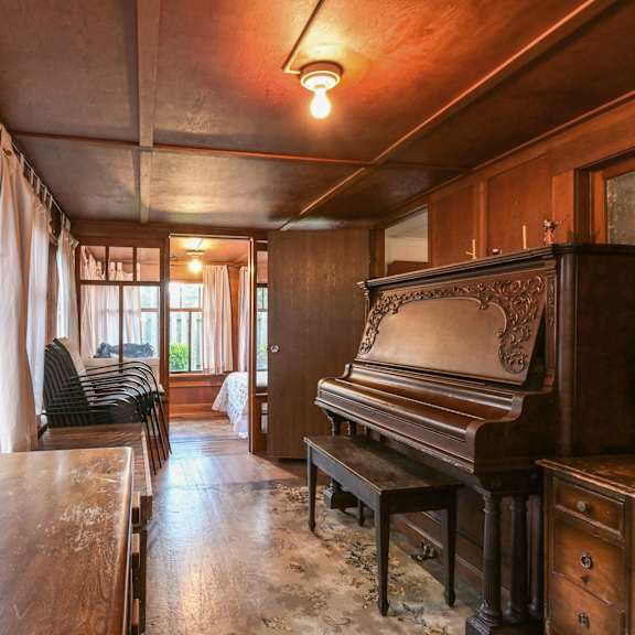 a room with a piano and a table.
