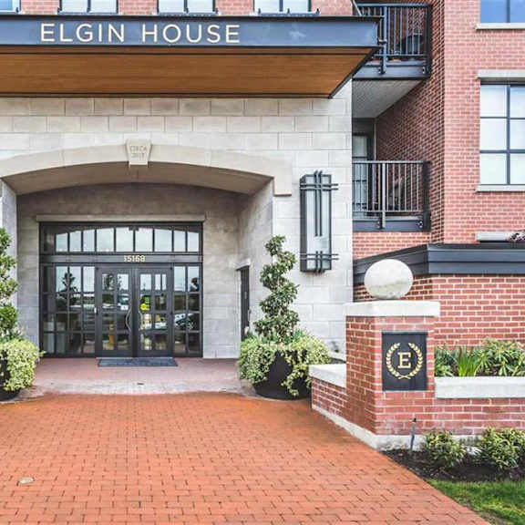 the entrance to elgin house is framed by two large planters.