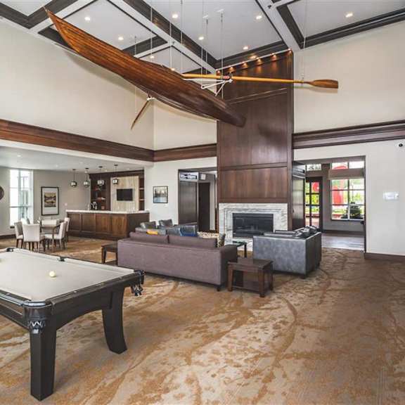 a billiard table is in the middle of a room with a fireplace.