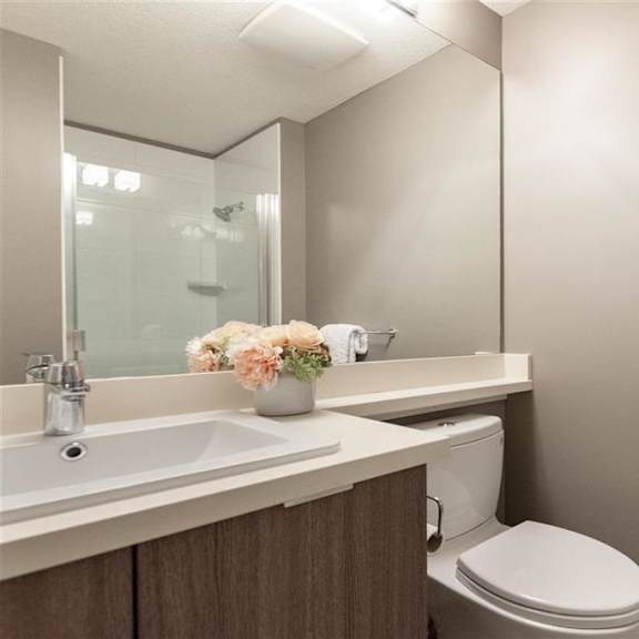 a white towel hangs on a towel rack in a bathroom.