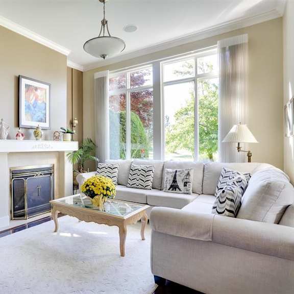 a living room with a fireplace, a chair, a couch, and a coffee table.