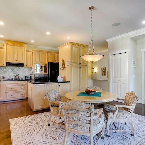 a kitchen with a table and chairs in the middle of the room.