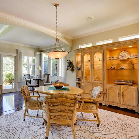 a well-lit dining room with a table set for six.
