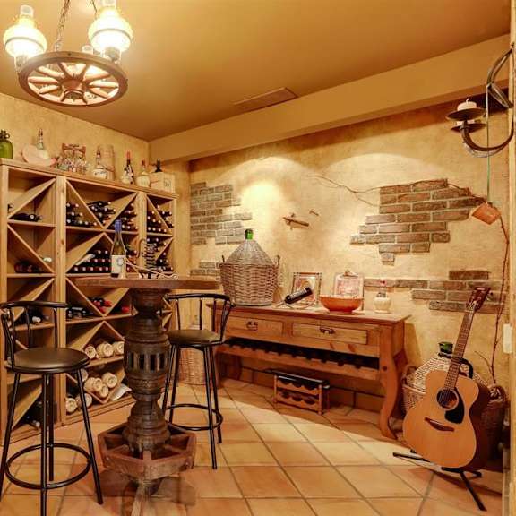 a room with a wine rack and a guitar.