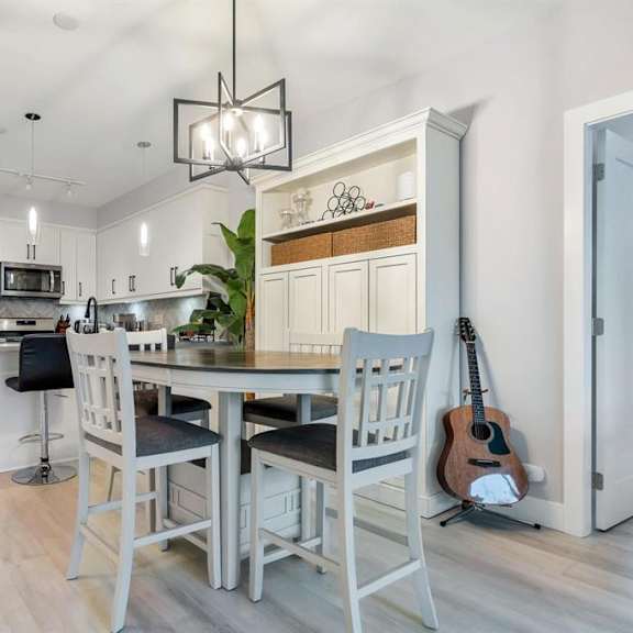 a kitchen with a dining table and chairs.