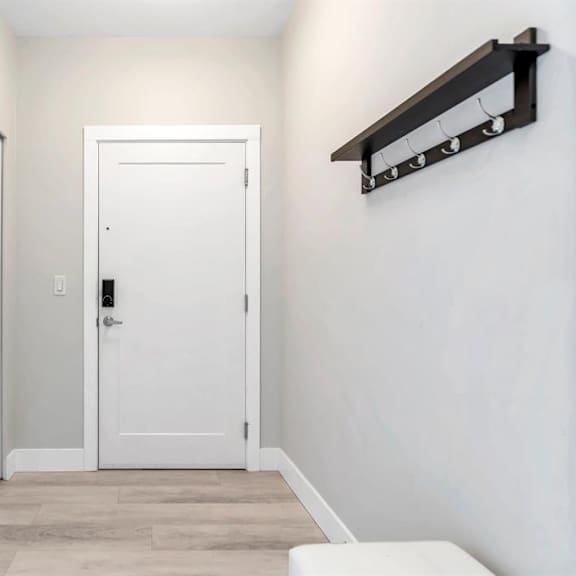 a white door is in the middle of a hallway.