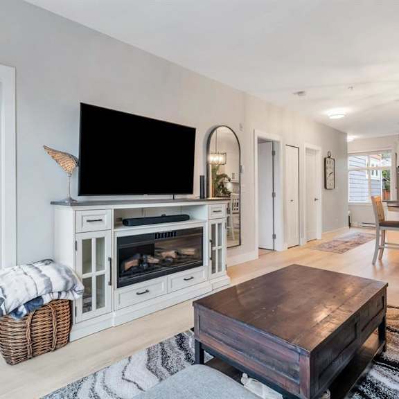 a modern living room with a flat screen tv and a fireplace.