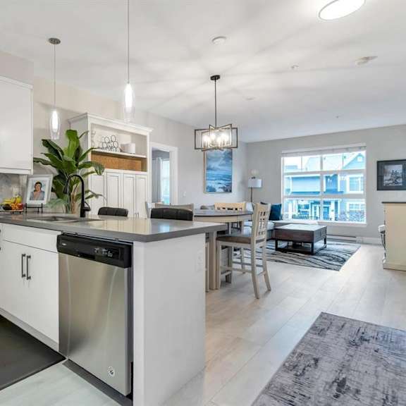 a modern kitchen with white cabinets and a large island.