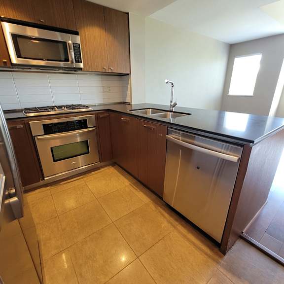 a kitchen with a stainless steel oven and microwave.