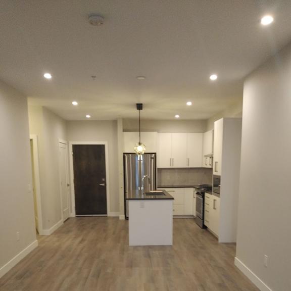 a kitchen area with a white island in the middle.