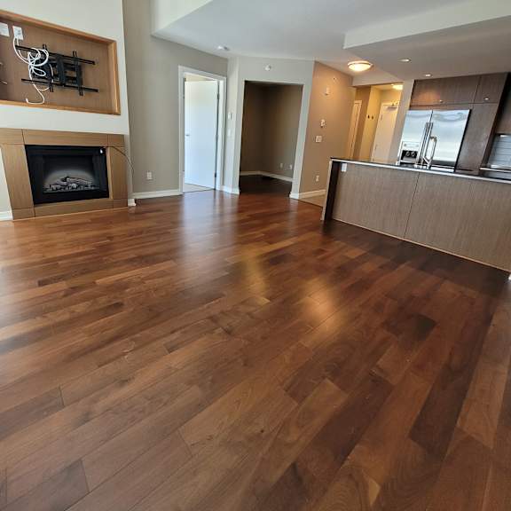 a wooden floor leads to a staircase.