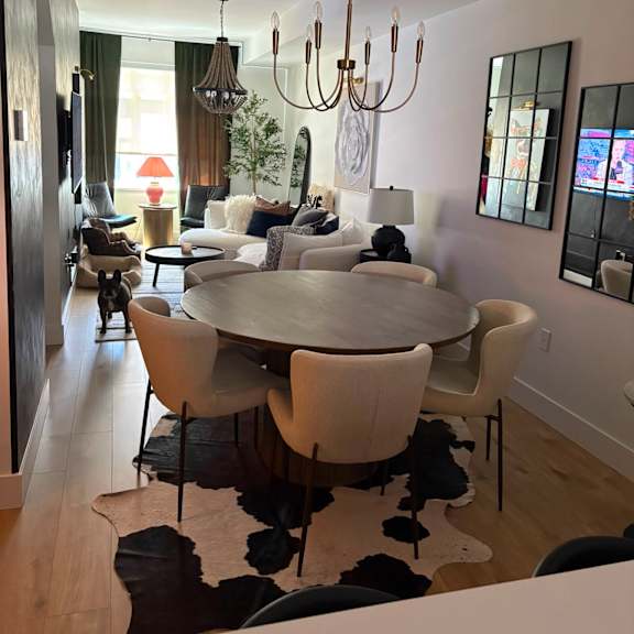 a modern dining room with a large table and chairs.