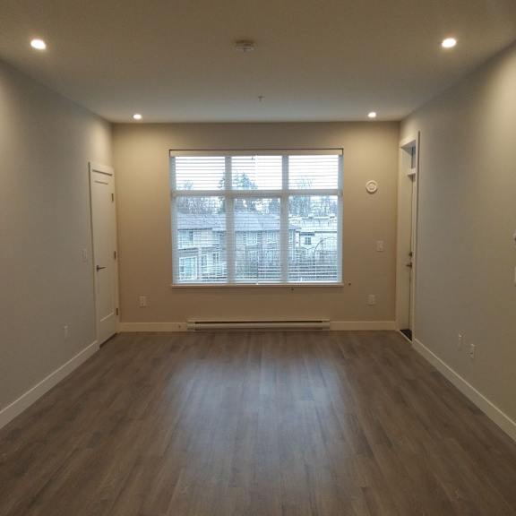 a room with wooden floors and a window.