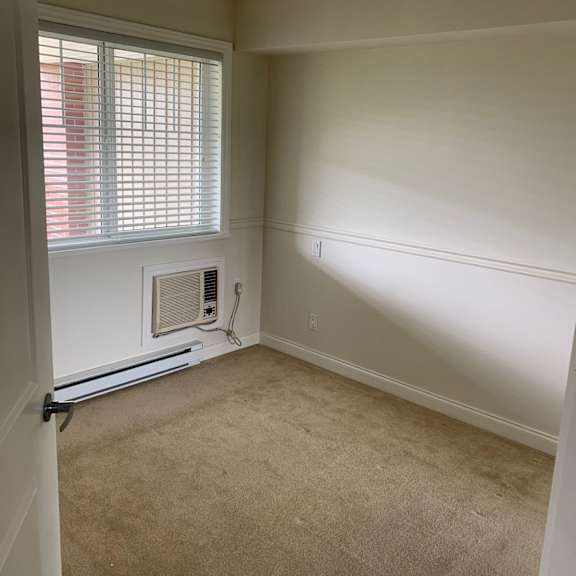 a room with a window and a radiator on the wall.