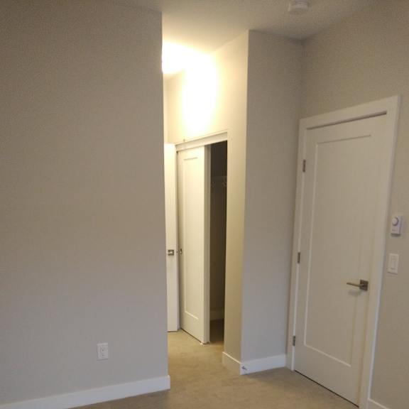 a hallway with two doors and a light on.