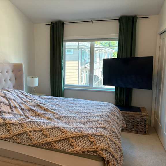 a bedroom with a large bed and a television.