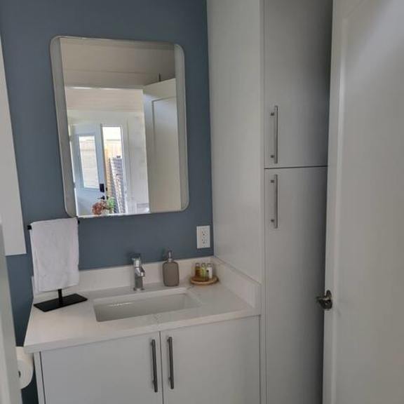 a bathroom with a sink and a mirror.