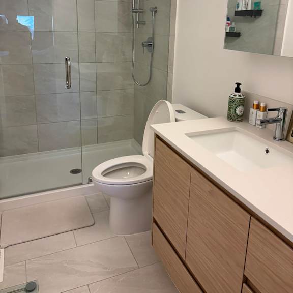 a white toilet sits in a bathroom next to a sink.
