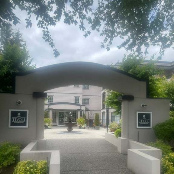a white archway with a sign that says "tivoli" on it.