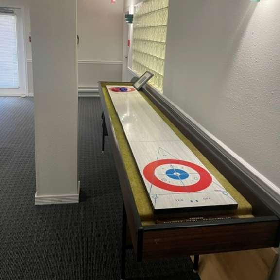 a long table with a target in the middle is in the middle of a room.