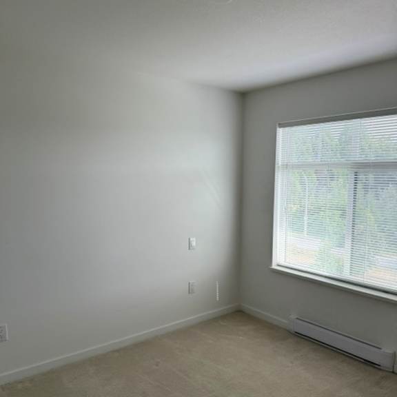 a room with a window and a wall socket.