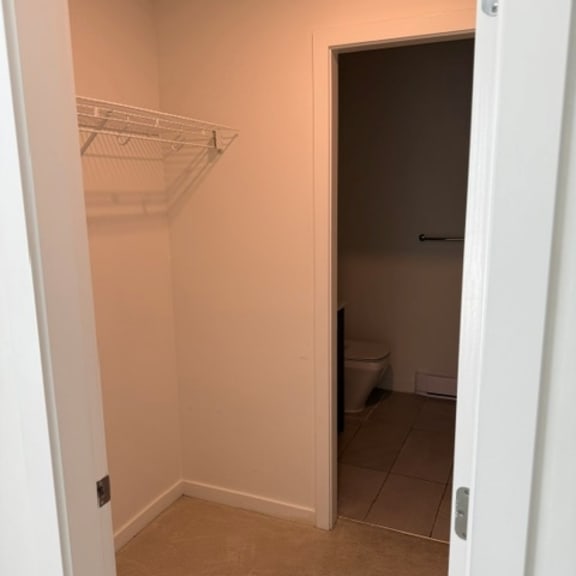 a white door is open to a bathroom.