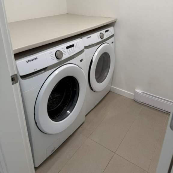 a small laundry room with a washer and dryer.