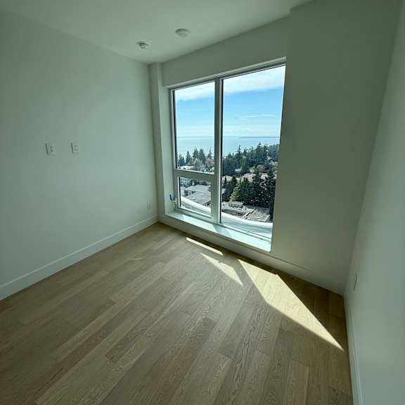 a skylight in a room with wooden flooring.