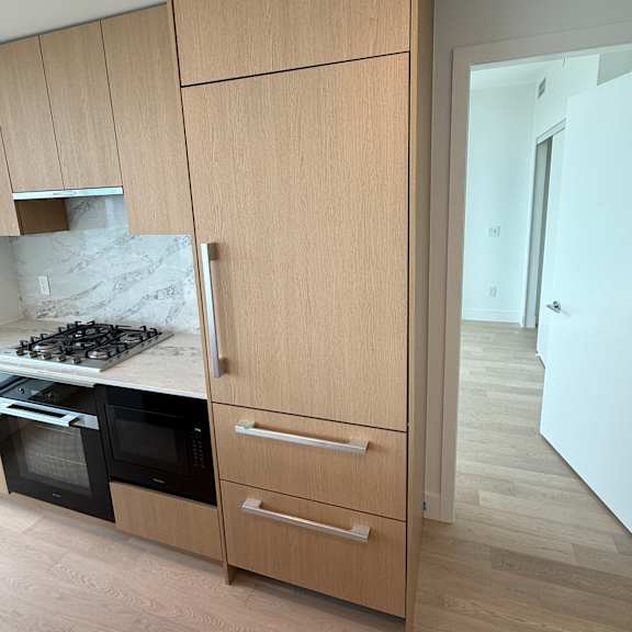 a kitchen with wooden cabinets and a skylight above.