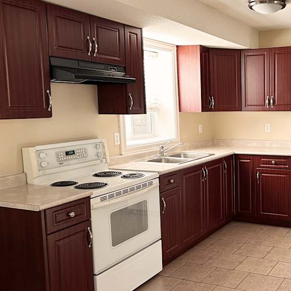 a kitchen with brown cabinets and a white refrigerator.