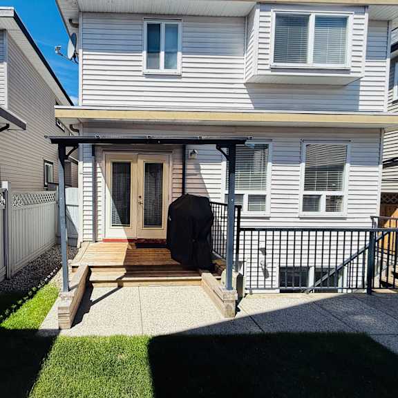 a house with a brown door and a small porch.