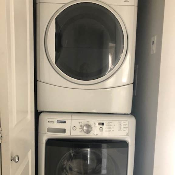 two white microwaves are placed next to each other.