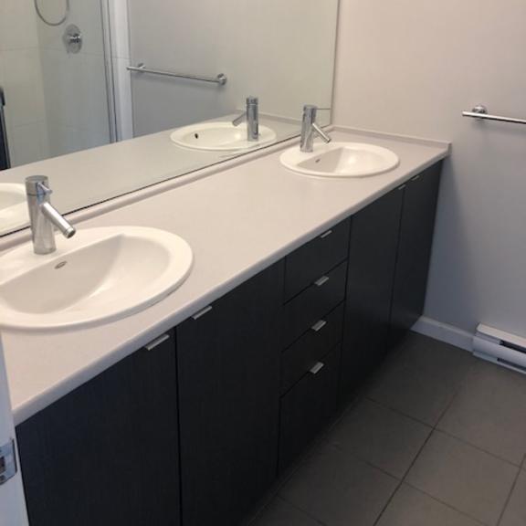 a white toilet with a white lid is in a bathroom.