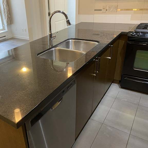 a kitchen with a sink and a dishwasher.