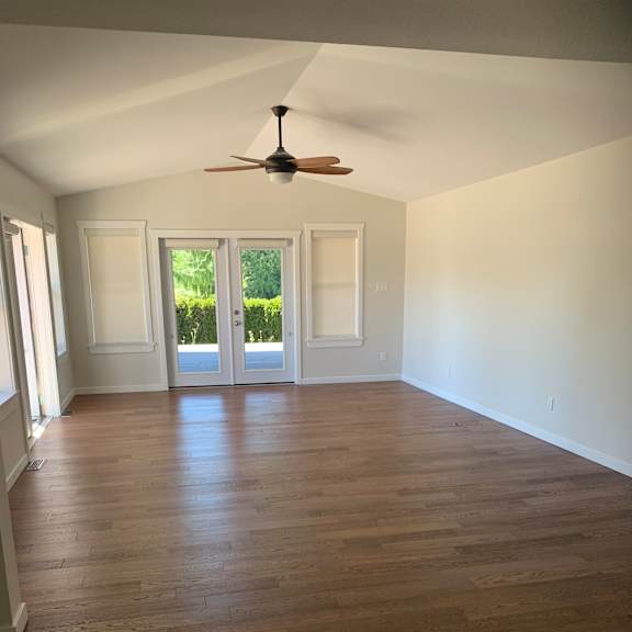 a room with a window and a ceiling fan.