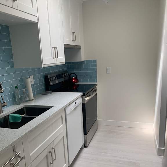 a kitchen under construction with unfinished cabinets and a countertop.