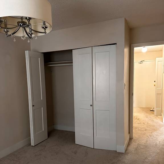 a white cabinet with a mirror above it is mounted on a wall.