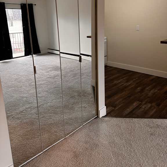 a staircase with a metal railing and a window.