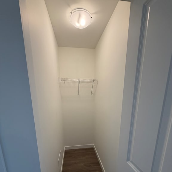 a white ceiling with a light fixture and a wooden cabinet.