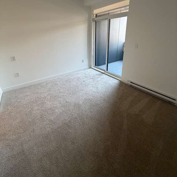 a window in a room with a carpeted floor.