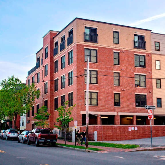 a red brick building with a stop sign in front of it.