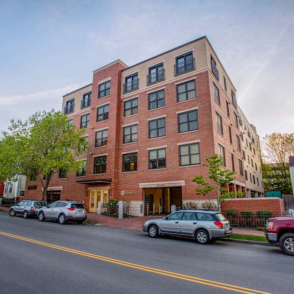 a red brick building with a yellow line in front of it.