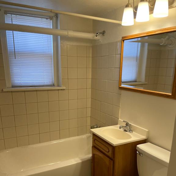 a white toilet sits next to a sink in a bathroom.